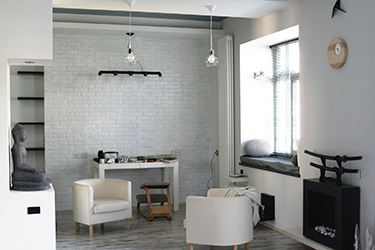 Lounge and study area with armchairs, sitting area on the windowsill and bio-fuel fireplace.