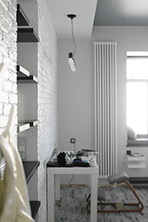 Another view of the study table, bookshelves next to it and ergonomic kneeling chair.