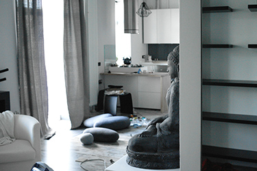 View to the kitchen from the built-in wardrobe with folding glass doors.