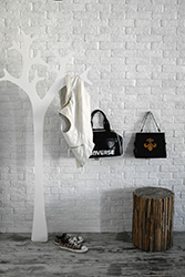 Coat hanger shaped as a tree and driftwood stool.