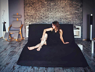 Right in the center of the apartment there is a faux brick wall and folding sofa-bed in partially Japanese style.