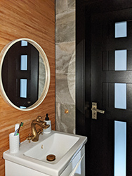 Waterproofed natural bamboo wallpaper and yellow bronze faucet shaped as a dragon. If you do Asia, don't be afraid of a bit of kitsch.