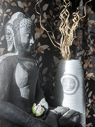 Traditonal Chinese prosperity symbol appears as a shadow on the vase during late afternoon hours.